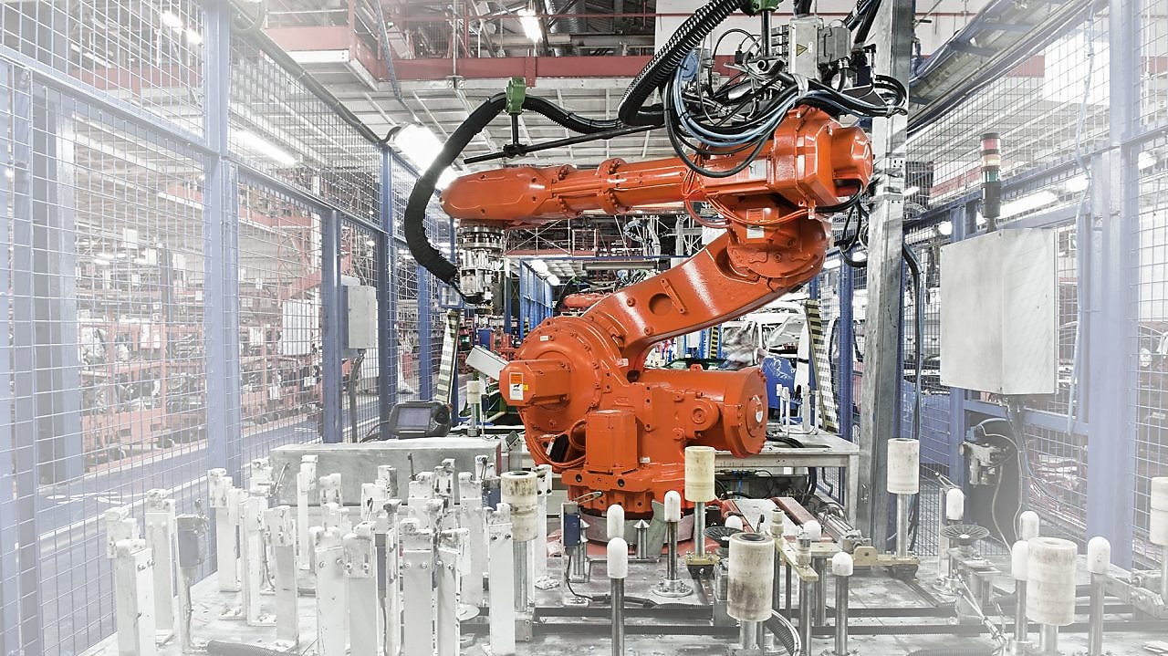 un bras robotisé rouge dans une usine