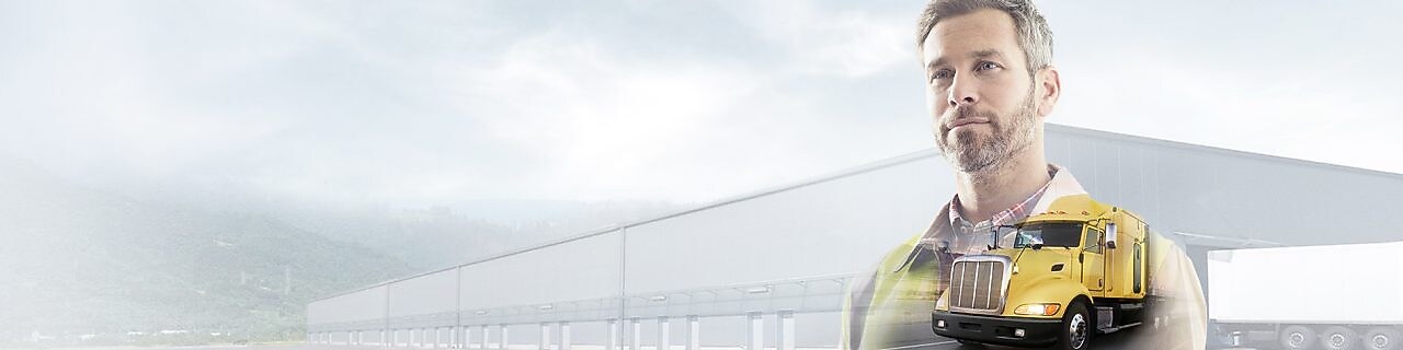 man reading a document transposed onto a background of a site and yellow truck